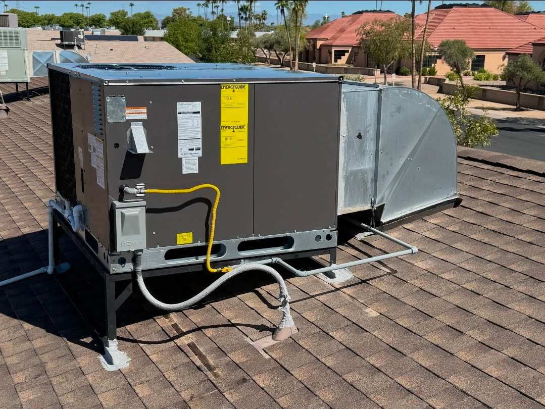 Packaged heating and cooling equipment with rooftop duct connections.