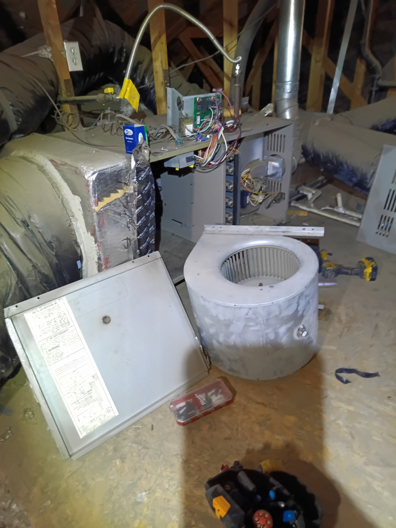 Furnace and blower assembly during an attic service visit.