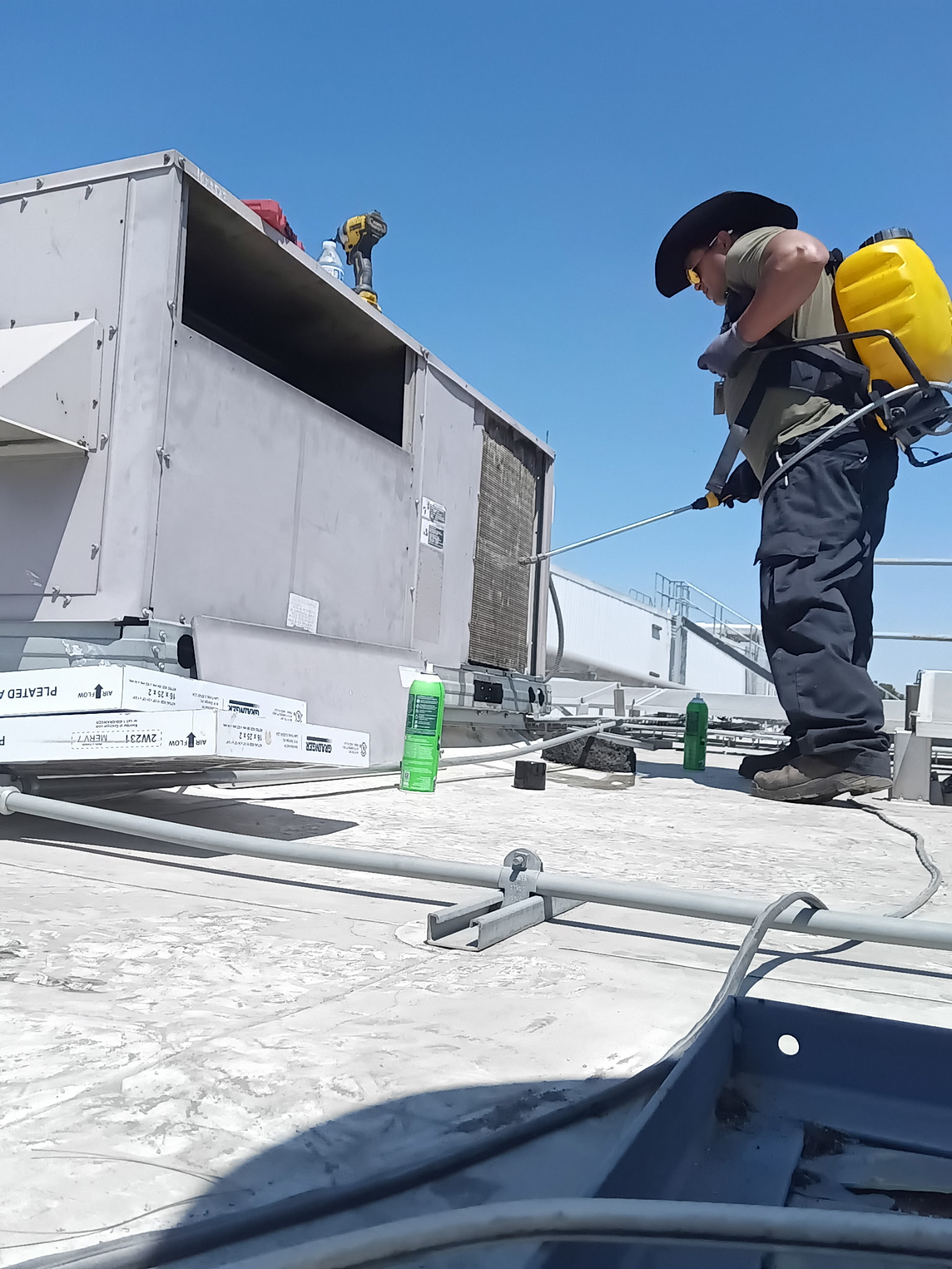Coil cleaning on a commercial rooftop HVAC unit.